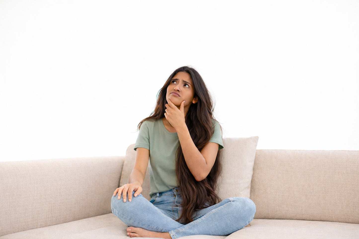 Woman thinking about choosing a healthy sanitary pad for better intimate skin and long-term comfort